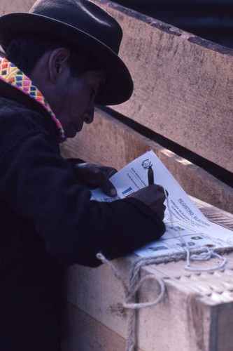 Mayan man filling out his ballot, Nahualá, 1982