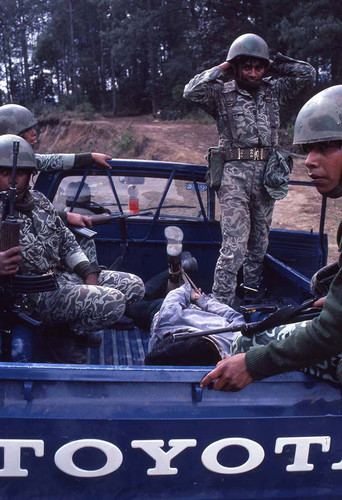 Soldiers and a hogtied man, Guatemala, 1982