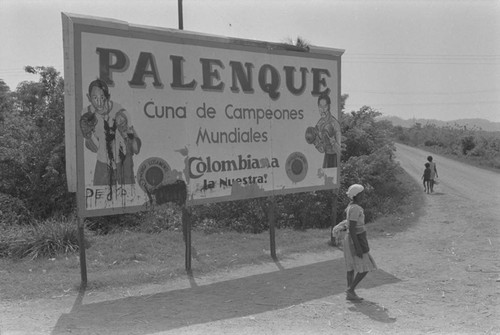 Woman walking by a billboard, Cartagena Province, ca. 1978