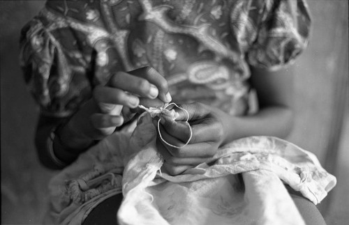 Girl sewing a garment, San Basilio de Palenque, 1977