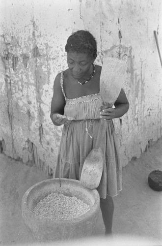 Woman grinding corn, San Basilio del Palenque, ca. 1978