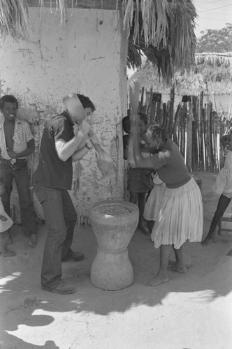 Richard Cross and woman grinding corn, San Basilio de Palenque, ca. 1978