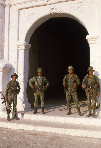 Four soldiers standing in front of church, Chajul, 1982