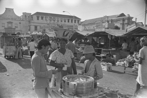 Boy selling drinks at city market, Cartagena Province, ca. 1978