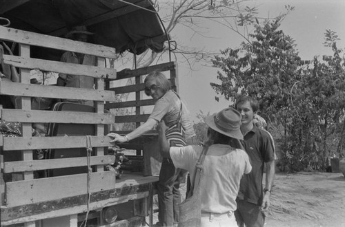 Nina S. de Friedemann and Richard Cross get on a truck, San Basilio del Palenque, ca. 1978