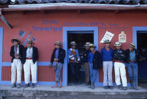 Mayan men leaning on a store wall, Chajul, 1982