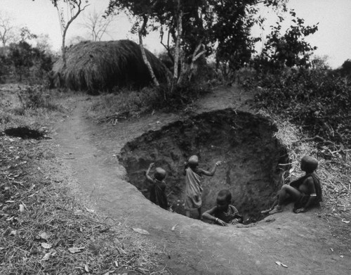 Children playing in hole, Tanzania, 1979