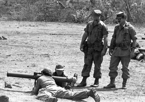 Two U.S. military advisors train Salvadoran army soldiers, Iiopango, 1983