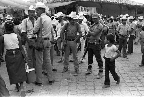 Boy looks at guerrilleros, Corinto, Morazán, 1983