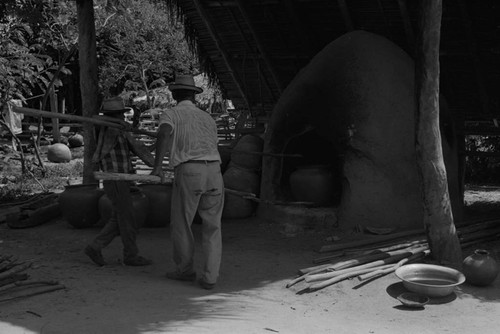 Man working the clay oven, La Chamba, Colombia, 1975