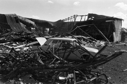 Destroyed building and car, Managua, 1980