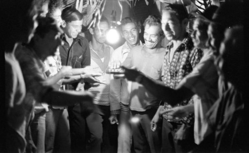 Men celebrating in the evening, Barranquilla, Colombia, 1977