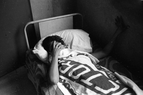 Injured woman in bed, Nicaragua, 1979