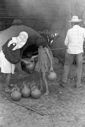 Man operating an oven, La Chamba, Colombia, 1975