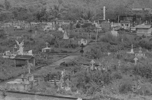 Distant view of a man landscaping a cemetery, Barbacoas, Colombia, 1979