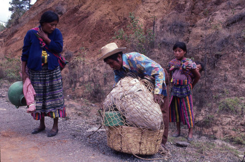 Mayan man putting together his belongings in a basket, Chichicastenango, 1982