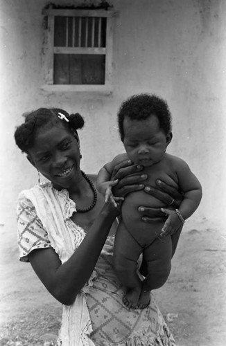 Woman holding a child in her arms, San Basilio de Palenque, 1975