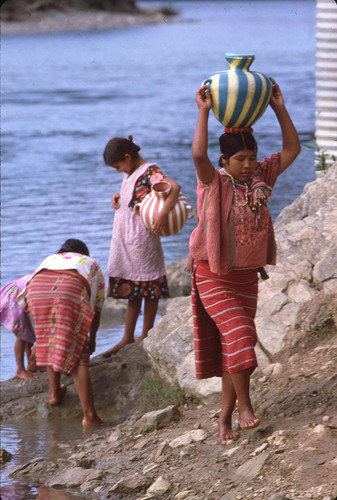 Guatemalan refugees collect water at a river, Chajul, ca. 1983