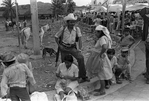 Armed man talks to a woman, Corinto, Morazán, 1983