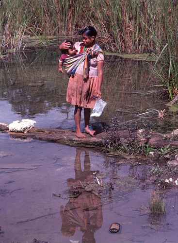 Guatemalan refugee washing her hair in the river, Cuauhtémoc, 1983