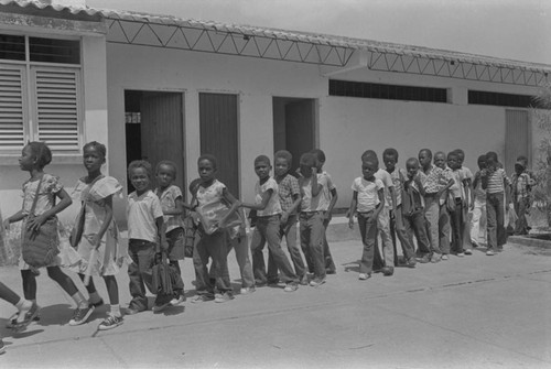 Students walking in line outside classroom, San Basilio de Palenque, ca. 1978