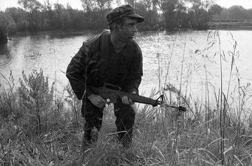 Survival school student holds a rifle, Liberal, 1982