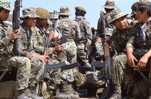 Soldiers ride in the back of a truck on patrol, Santa Cruz del Quiché, 1982