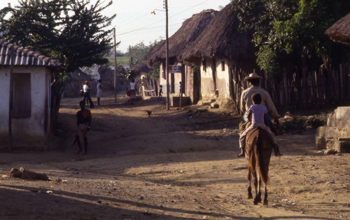 Man and child on a mule, San Basilio de Palenque, 1976