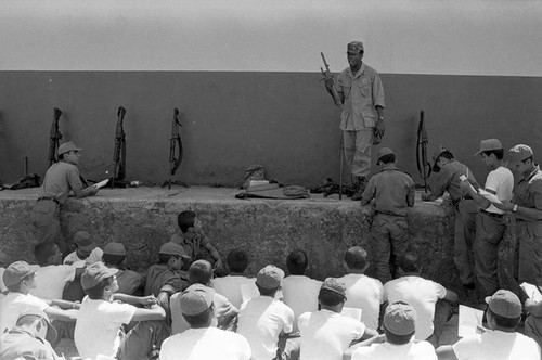 U.S. advisor training Salvadoran soldiers at military base, Ilopango, 1983