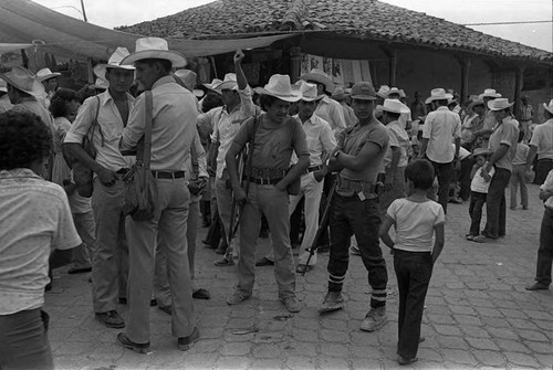 Boy looks at guerrilleros, Corinto, Morazán, 1983