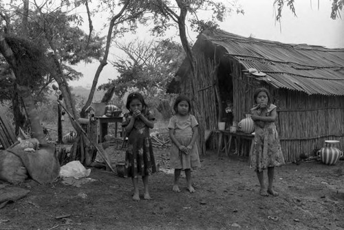 Refugee girls outside of a hut, Chiapas, 1983