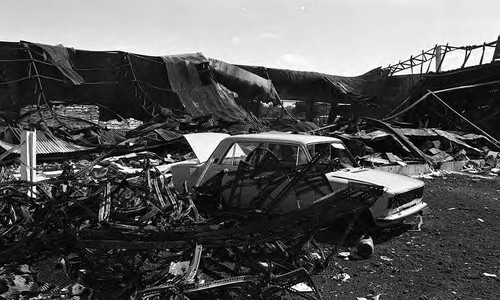 Destroyed building and car, Managua, 1980