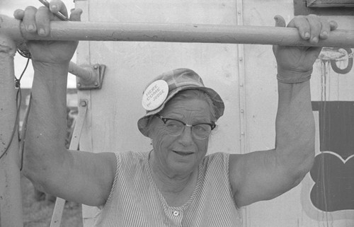 Woman wearing a hat with political button