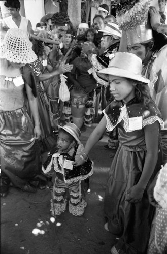 Young dancers walking among a crowd, Barranquilla, Colombia, 1977