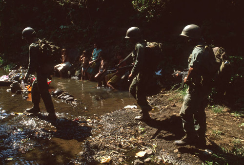 Soldiers walking in a creek, Usulután, El Salvador, 1982