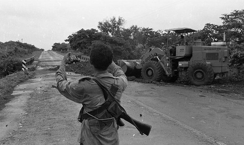 Man looks towards a tractor on a bridge, Nicaragua, 1979