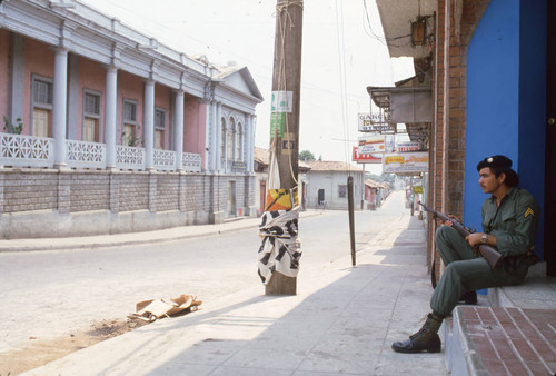 Soldier sitting while on guard, Usulután, El Salvador, 1982