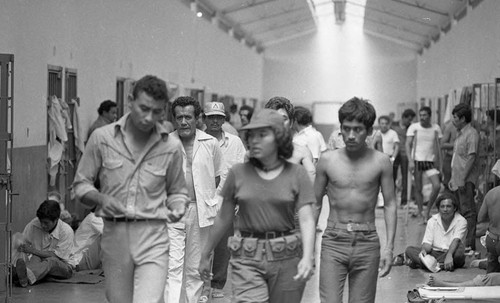 People walk through prison hallway, Nicaragua, 1980