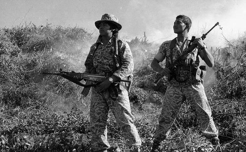 Armed soldiers on a smoking mountain, Guatemala, 1982