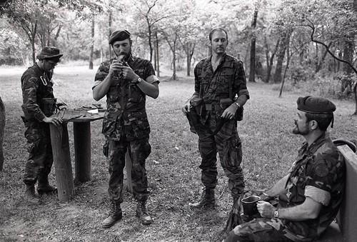 Survival school students stand near Harry Claflin and an assistant, Liberal, 1982