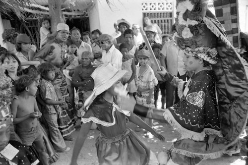 Girl and boy dancing among a crowd, Barranquilla, Colombia, 1977