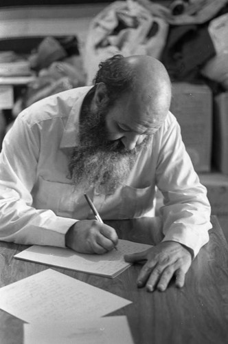 Man writes on document, Mexico City, 1982