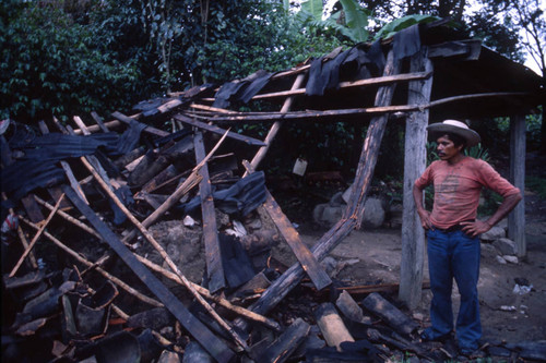 Man looks at destroyed shack, Honduras, 1983