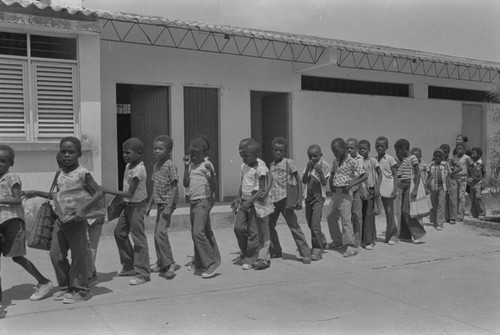 Students walking in line outside classroom, San Basilio de Palenque, ca. 1978