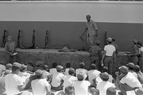 A U.S. military advisor speaks to a group of cadets, Ilopango, 1983