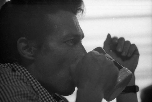 Side profile of Roberto D'Aubuisson drinking from a mug, San Salvador, 1982