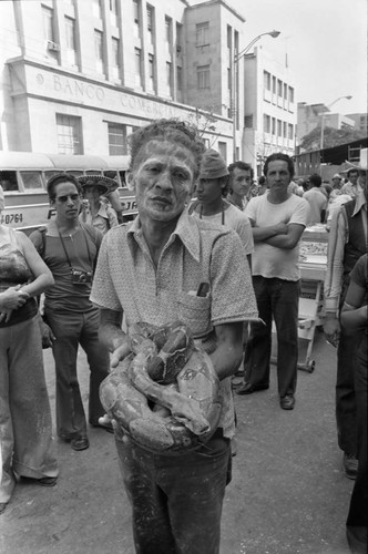 Man holding a snake, Barranquilla, Colombia, 1977