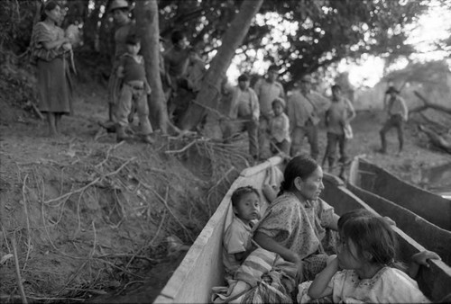 Refugee woman and three children in a canoe, Chiapas, 1983