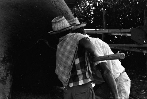 Men operating an oven, La Chamba, Colombia, 1975