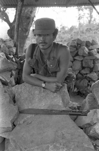 A Salvadoran Army soldier with a machete stands at an outpost , Perquín, 1983